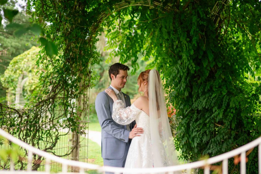 Bride and groom sharing a quiet moment under greenery on their wedding day in Northeast Ohio