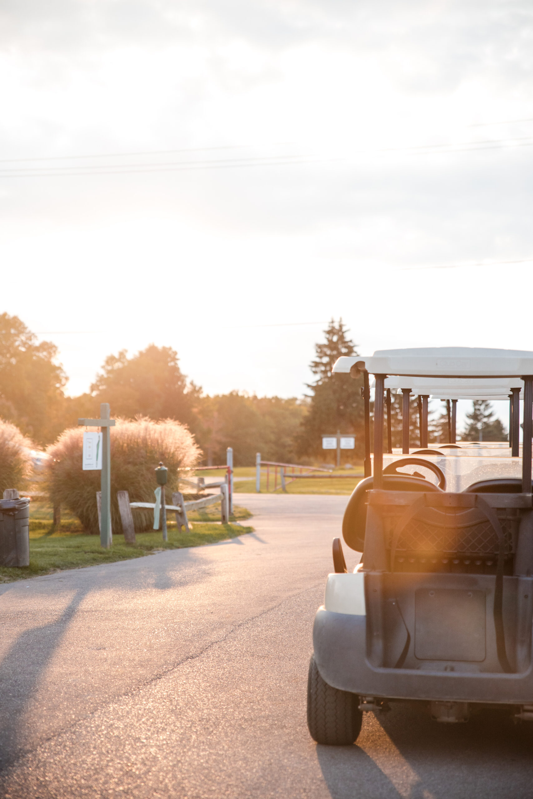 Empty golf cart at golden hour, Cleveland golf course wedding
