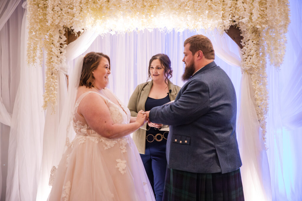 Couple exchanging vows during a wedding ceremony at The Venue Banquet Center in Tallmadge Ohio