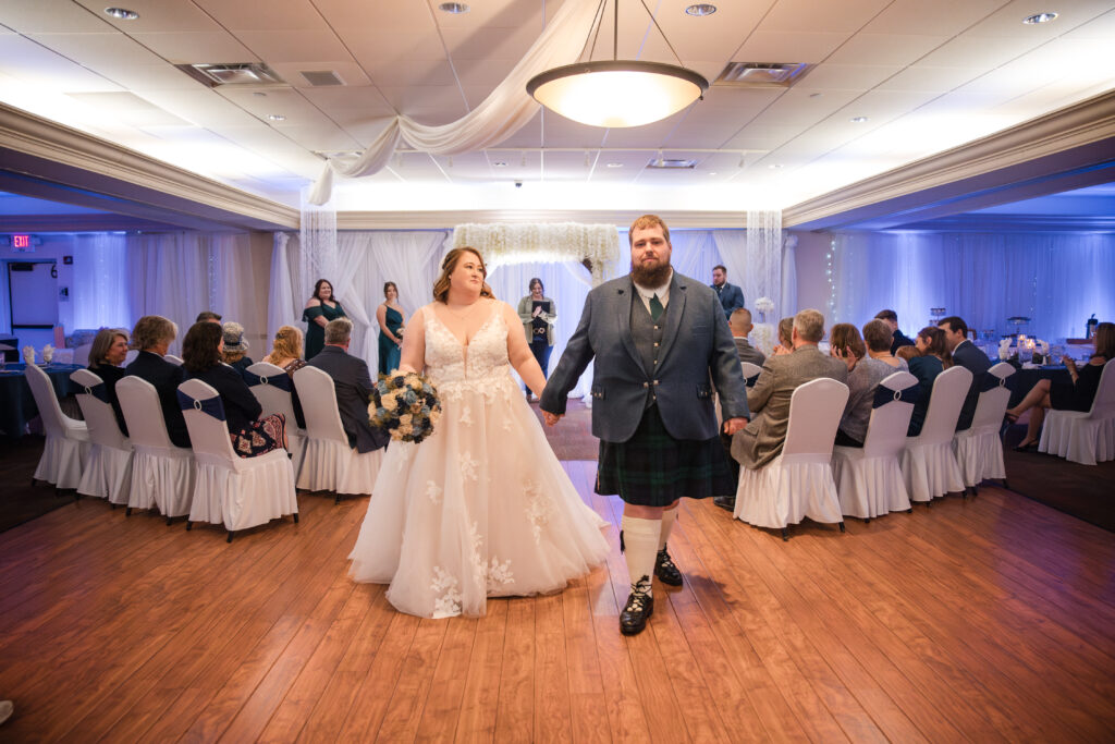 Couple exchanging vows during a wedding ceremony at The Venue Banquet Center in Tallmadge Ohio
