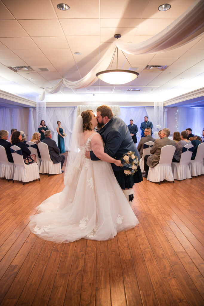 Couple exchanging vows during a wedding ceremony at The Venue Banquet Center in Tallmadge Ohio