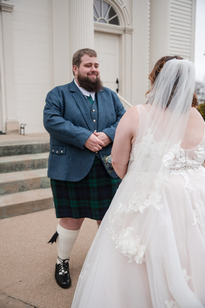 Groom wearing a traditional kilt during a winter wedding first look