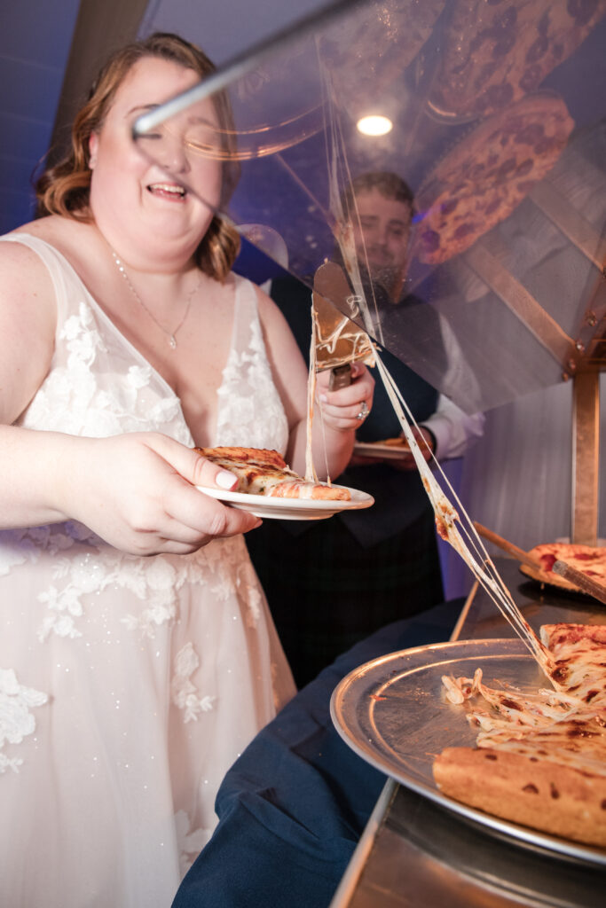 Bride enjoying late night pizza during a Tallmadge Ohio wedding reception