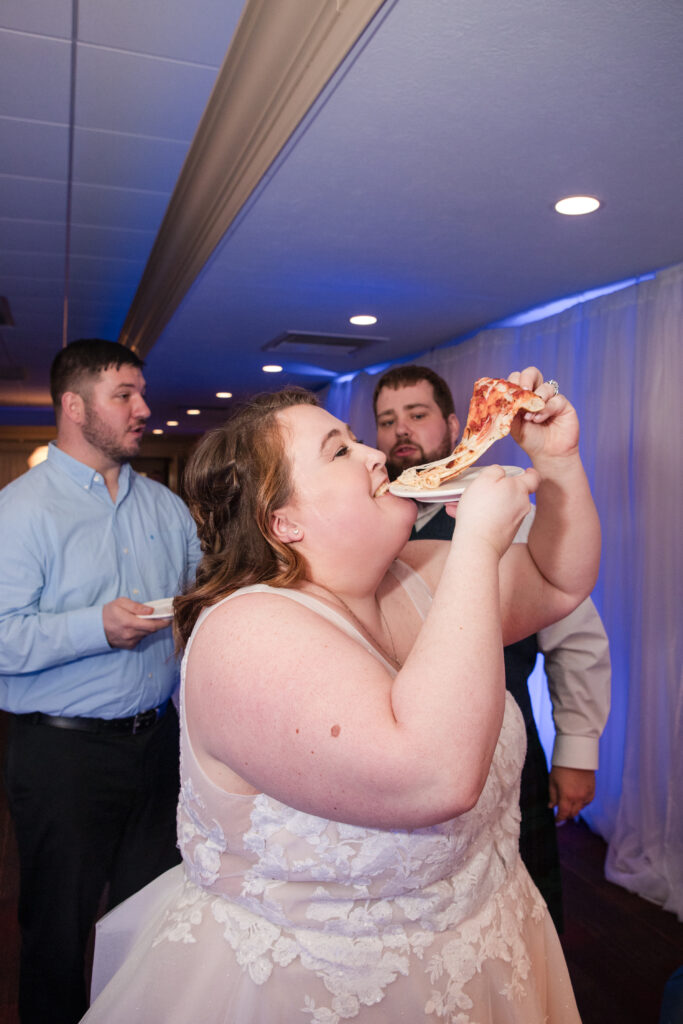 Bride enjoying late night pizza during a Tallmadge Ohio wedding receptionBride enjoying late night pizza during a Tallmadge Ohio wedding reception