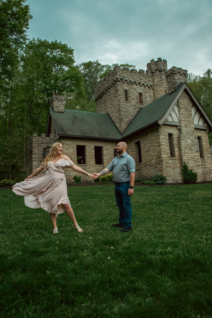 Couple dancing in front of Squire’s Castle in Willoughby Hills during Cleveland engagement session.
