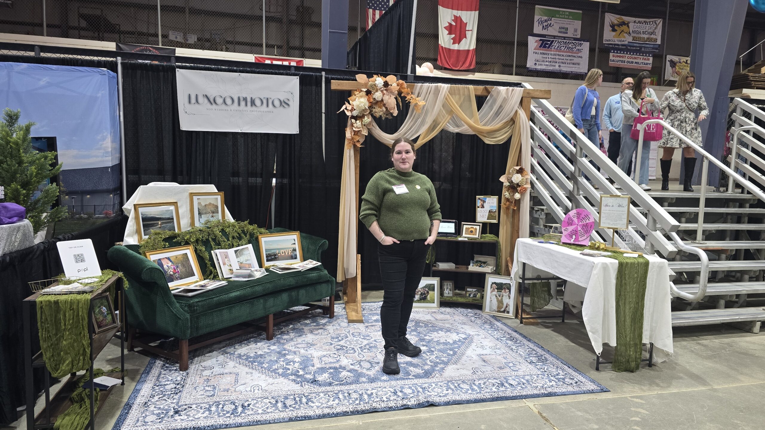 wedding show vendor tips booth setup featuring Luxco Photos display with couch and arch at the Today’s Bride Show