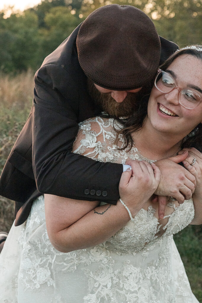 Candid wedding portrait of the couple laughing during golden hour near Himelright Lodge in Cascade Valley Metro Park