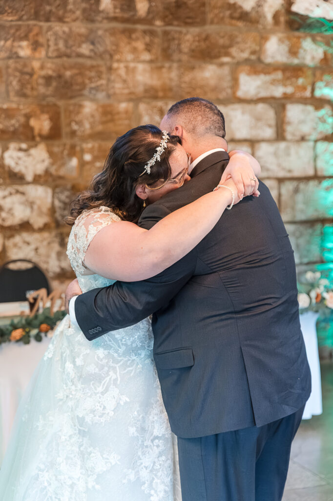 Bride dancing with her dad during the wedding reception inside Himelright Lodge
