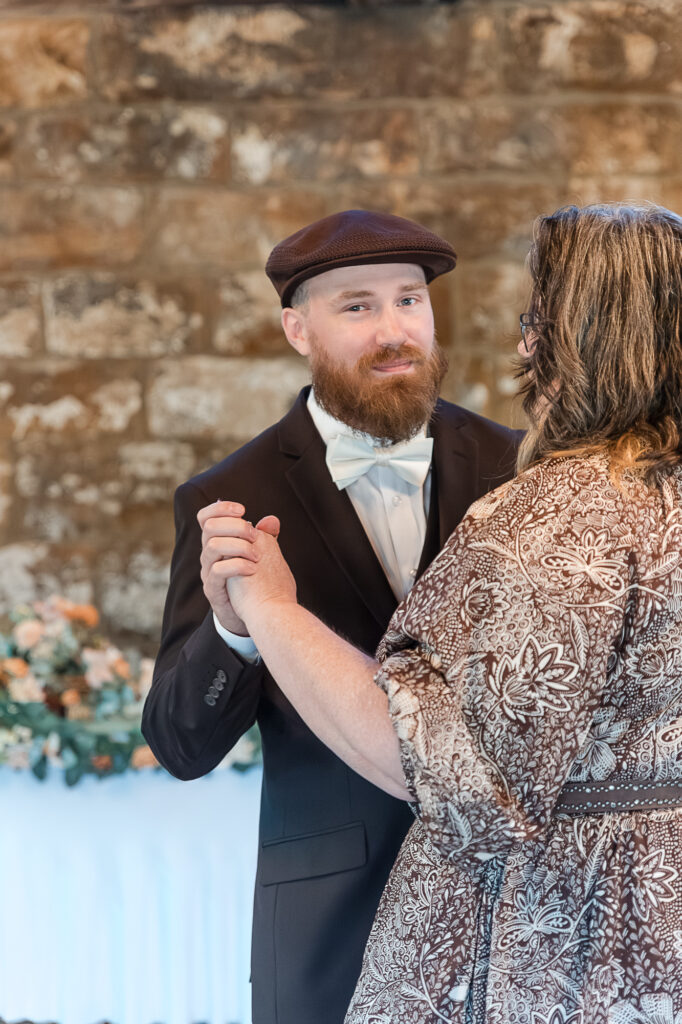 Groom dancing with his mom during the wedding reception inside Himelright Lodge