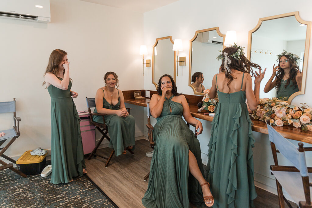Bridesmaids getting ready inside the Himelright Lodge wedding suite with natural light and makeup stations.