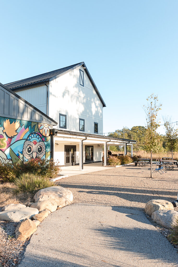 Exterior view of Himelright Lodge at Cascade Valley Metro Park with mural and covered porch
